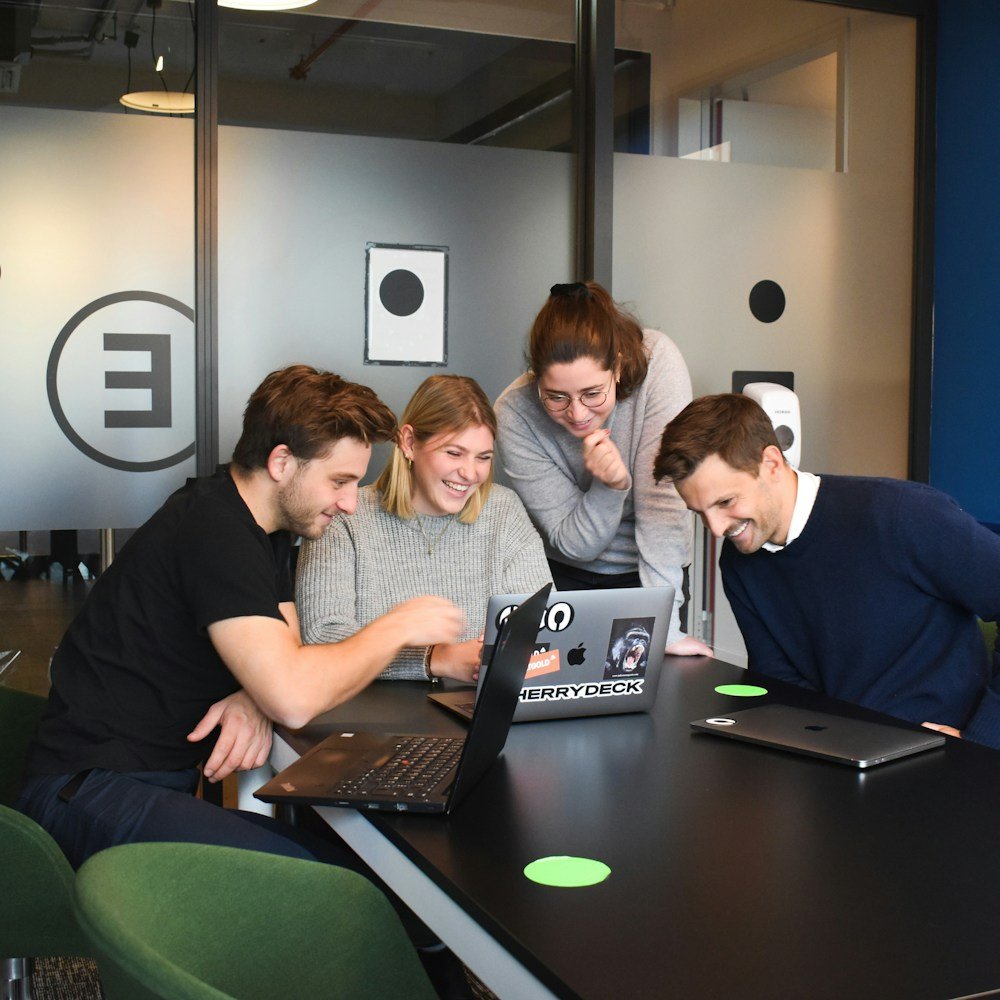 A diverse group of students collaborating over futuristic maps and digital tools in a bright, modern classroom.